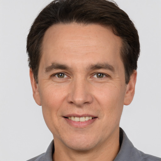 Joyful white adult male with short  brown hair and brown eyes