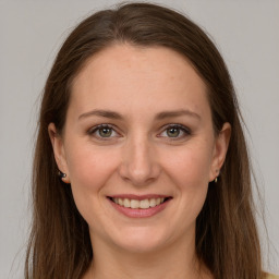 Joyful white young-adult female with long  brown hair and grey eyes