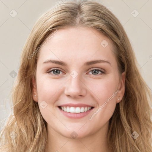 Joyful white young-adult female with long  brown hair and blue eyes