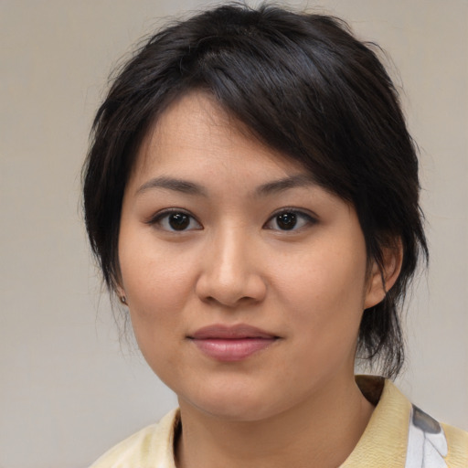 Joyful asian young-adult female with medium  brown hair and brown eyes