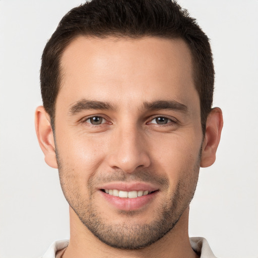 Joyful white young-adult male with short  brown hair and brown eyes