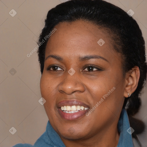 Joyful black young-adult female with long  black hair and brown eyes