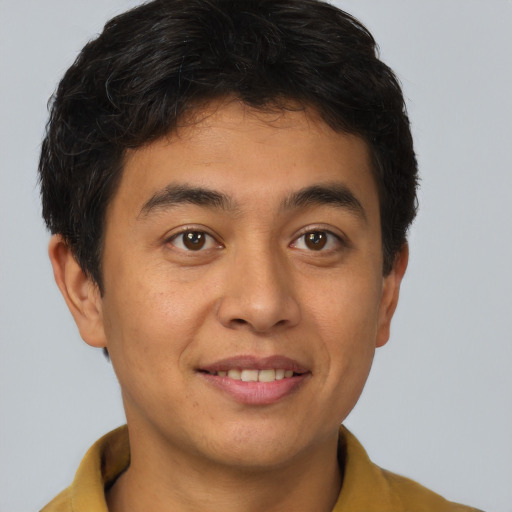 Joyful asian young-adult male with short  brown hair and brown eyes