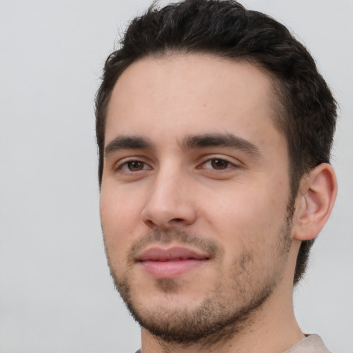 Joyful white young-adult male with short  black hair and brown eyes