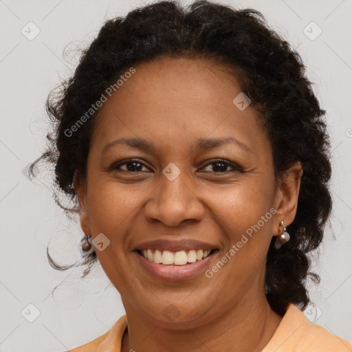 Joyful black adult female with medium  brown hair and brown eyes