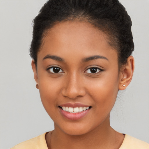 Joyful latino young-adult female with short  brown hair and brown eyes