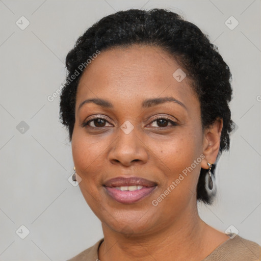 Joyful black adult female with short  black hair and brown eyes