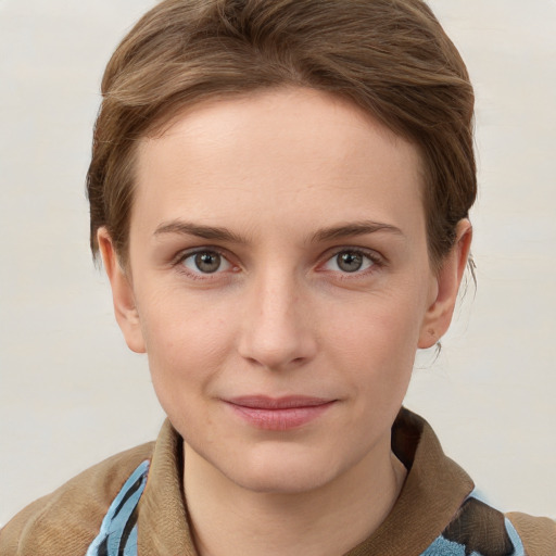 Joyful white young-adult female with short  brown hair and blue eyes