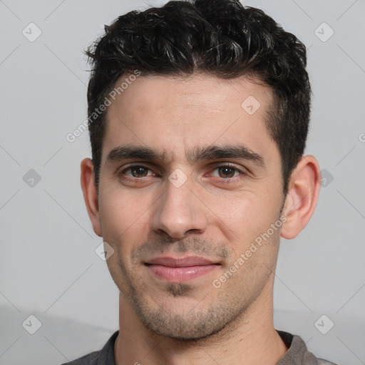 Joyful white young-adult male with short  black hair and brown eyes