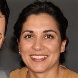 Joyful white adult female with short  brown hair and brown eyes