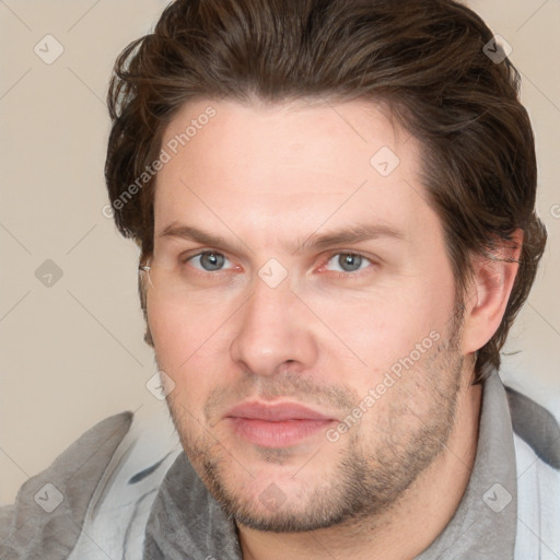 Joyful white adult male with short  brown hair and grey eyes