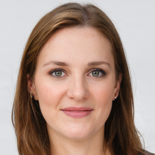 Joyful white young-adult female with long  brown hair and green eyes