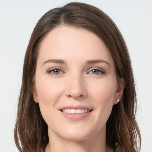 Joyful white young-adult female with long  brown hair and grey eyes