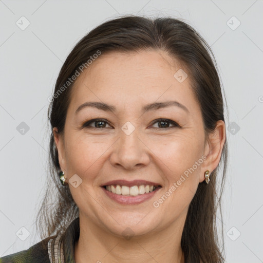 Joyful white adult female with long  brown hair and brown eyes