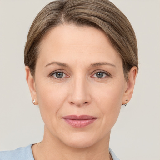 Joyful white adult female with short  brown hair and grey eyes