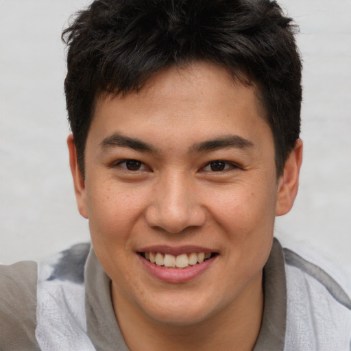 Joyful asian young-adult male with short  brown hair and brown eyes