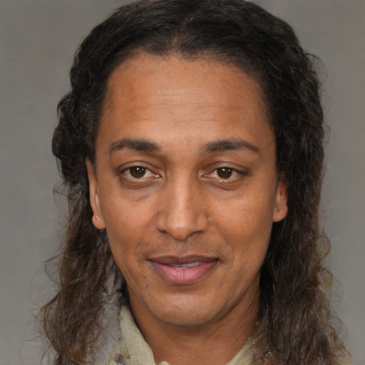 Joyful black adult female with medium  brown hair and brown eyes