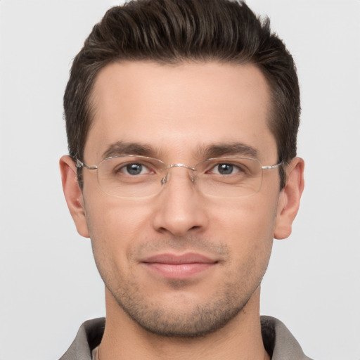 Joyful white young-adult male with short  brown hair and brown eyes