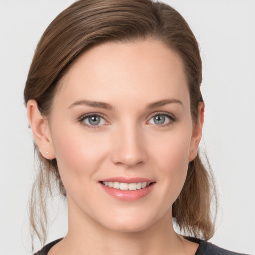 Joyful white young-adult female with medium  brown hair and grey eyes