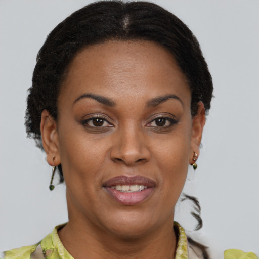 Joyful black young-adult female with short  brown hair and brown eyes
