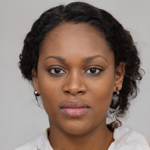 Neutral black young-adult female with medium  brown hair and brown eyes