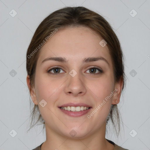 Joyful white young-adult female with medium  brown hair and grey eyes