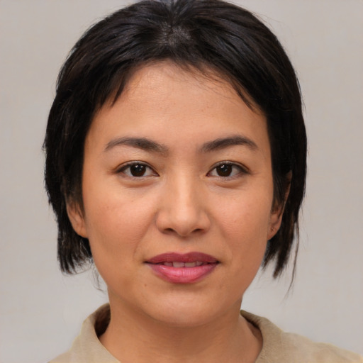 Joyful asian young-adult female with medium  brown hair and brown eyes