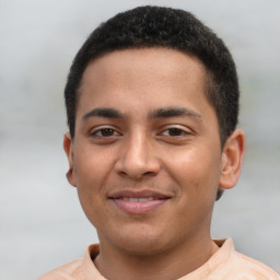 Joyful latino young-adult male with short  brown hair and brown eyes