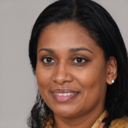 Joyful black adult female with medium  brown hair and brown eyes