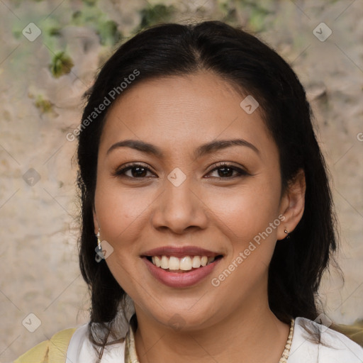 Joyful latino young-adult female with medium  brown hair and brown eyes