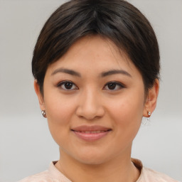 Joyful asian young-adult female with short  brown hair and brown eyes