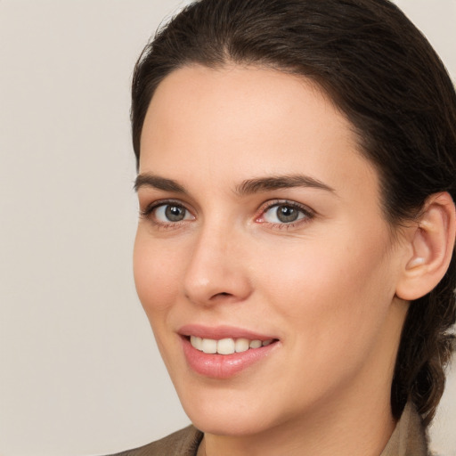 Joyful white young-adult female with medium  brown hair and brown eyes