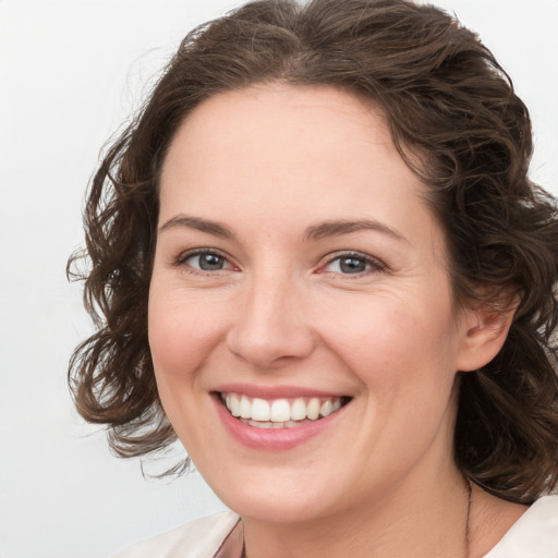 Joyful white young-adult female with medium  brown hair and green eyes