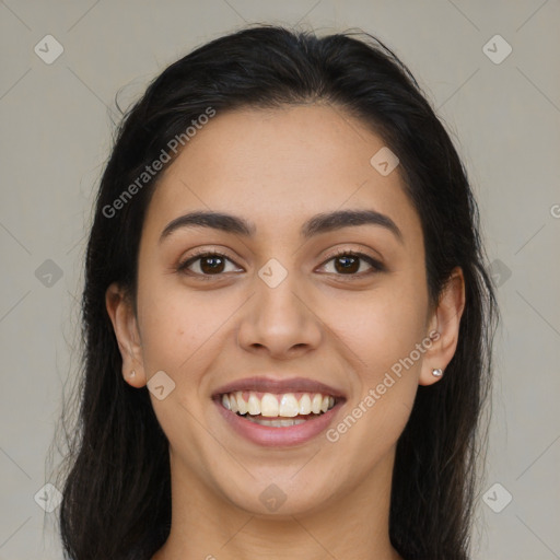 Joyful latino young-adult female with long  brown hair and brown eyes