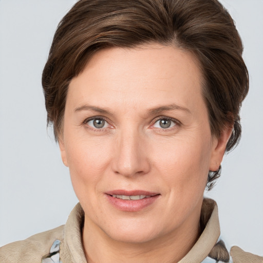 Joyful white adult female with medium  brown hair and grey eyes