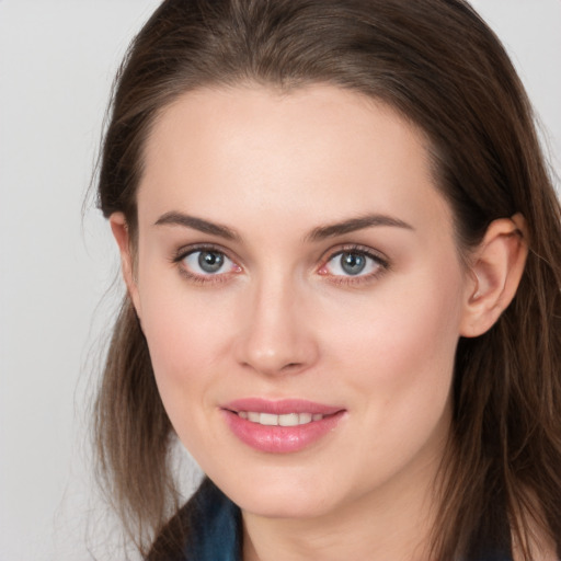 Joyful white young-adult female with long  brown hair and grey eyes