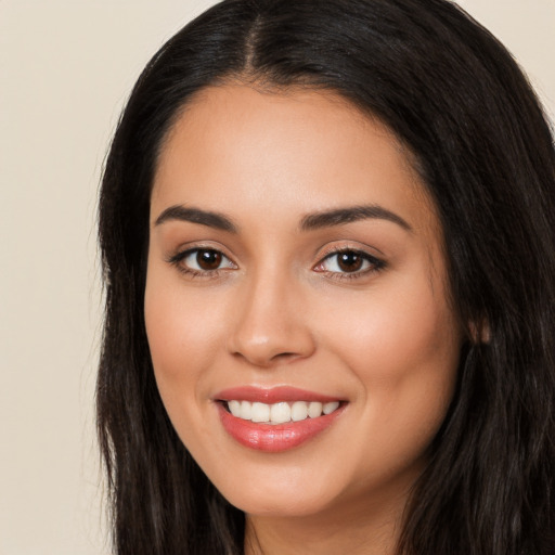 Joyful white young-adult female with long  black hair and brown eyes