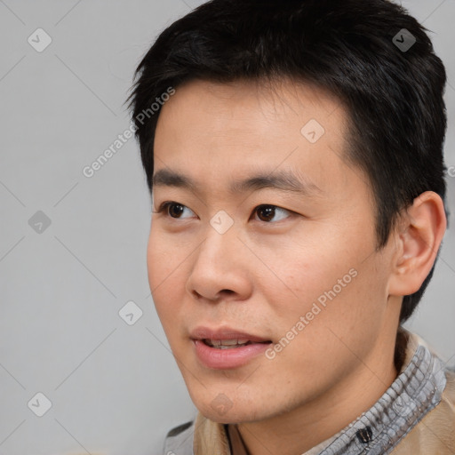 Joyful asian young-adult male with short  black hair and brown eyes