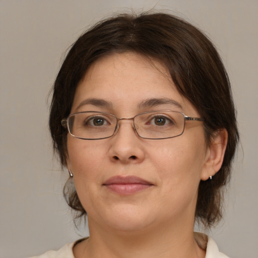 Joyful white adult female with medium  brown hair and brown eyes