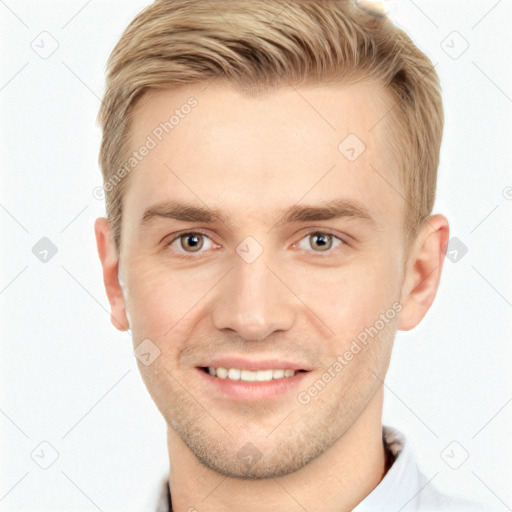 Joyful white young-adult male with short  brown hair and grey eyes