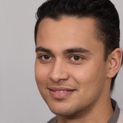 Joyful white young-adult male with short  brown hair and brown eyes