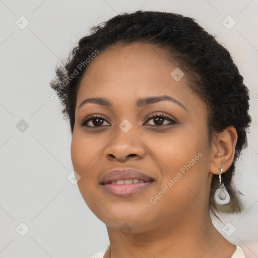 Joyful black young-adult female with long  black hair and brown eyes