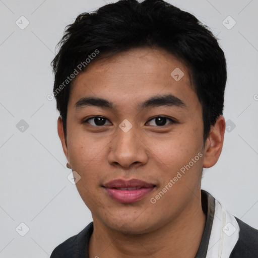 Joyful asian young-adult male with short  black hair and brown eyes