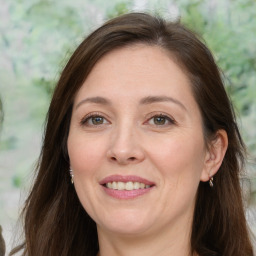 Joyful white adult female with long  brown hair and brown eyes