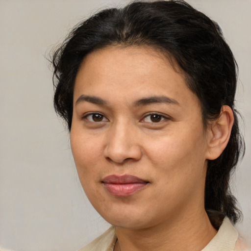 Joyful latino adult female with medium  brown hair and brown eyes