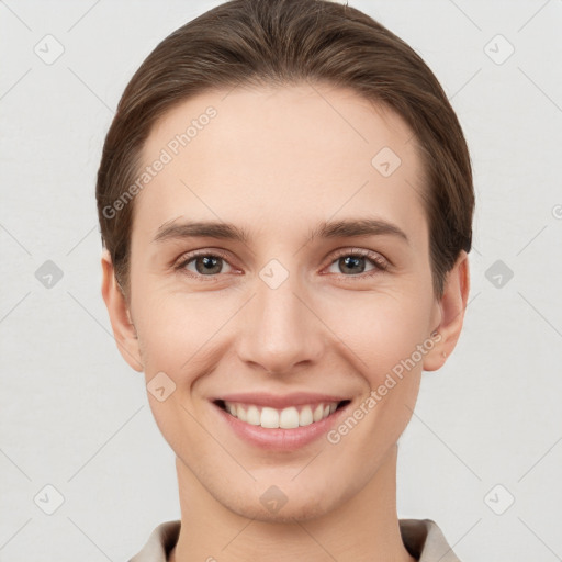 Joyful white young-adult female with short  brown hair and brown eyes