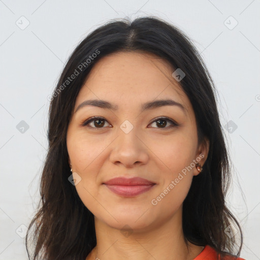 Joyful latino young-adult female with long  brown hair and brown eyes