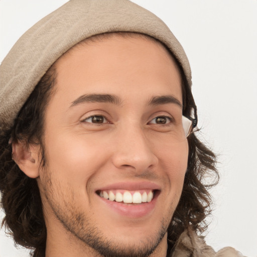 Joyful white young-adult male with long  brown hair and brown eyes