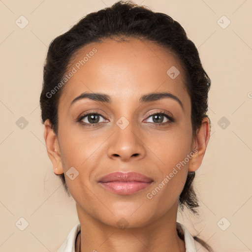 Joyful latino young-adult female with short  brown hair and brown eyes