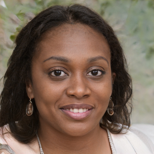 Joyful black young-adult female with medium  brown hair and brown eyes